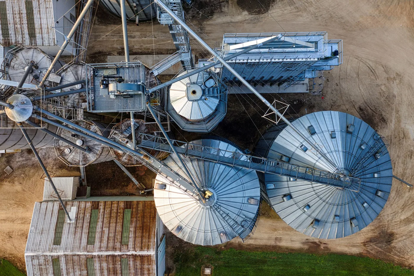Grain storage silos at a receival site with a truck delivering grain.